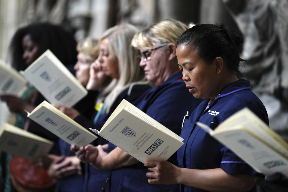 Nurses sing, during the NHS anniversary ceremony at Westminster Abbey, part of the health service's 75th anniversary celebrations, in London, Wednesday, July 5, 2023. The U.K. is celebrating the 75th birthday of its beloved but increasingly creaky National Health Service. The date is being marked with charity tea parties, royal visits and a service of thanksgiving at London’s Westminster Abbey. (Jordan Pettitt/PA via AP)