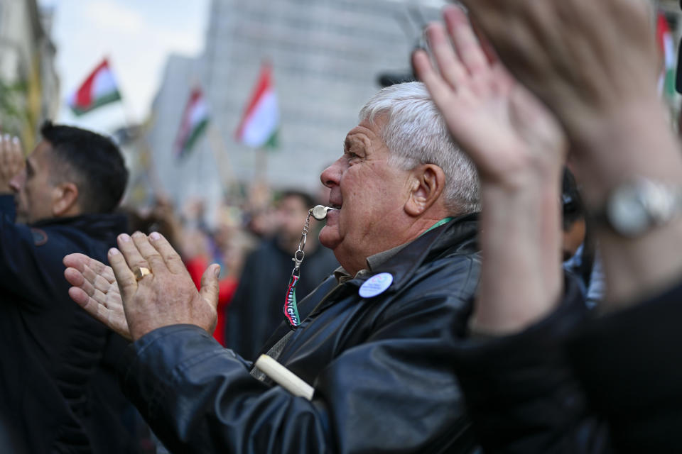 A man blows a whistle during a protest outside the Hungarian Interior Ministry building to demand stronger protections for children and Interior minister Sandor Pinter to step down, in Budapest, Hungary, Friday, April 26, 2024. Peter Magyar, a former insider within Orban's ruling Fidesz party, lead a protest. The demonstration was the latest in a series of large anti-government protests that Magyar has mobilized in recent weeks, and comes as the political newcomer is campaigning for EU elections this June with his new party, Respect and Freedom (TISZA). (AP Photo/Denes Erdos)