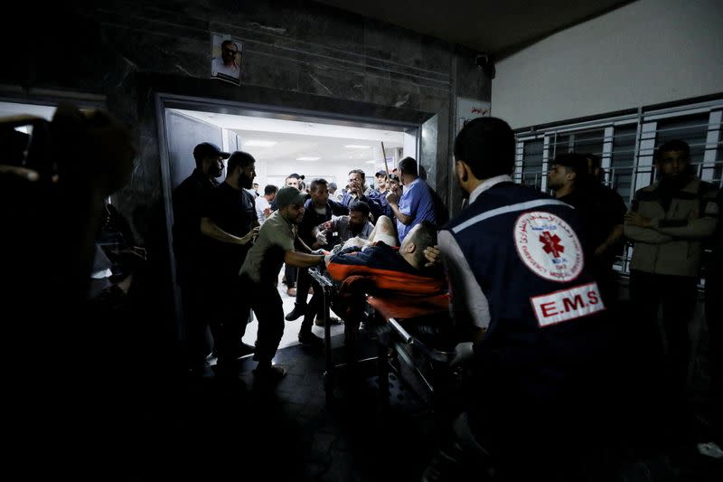 People are assisted at Shifa Hospital after an Israeli air strike hit the nearby Al-Ahli Hospital