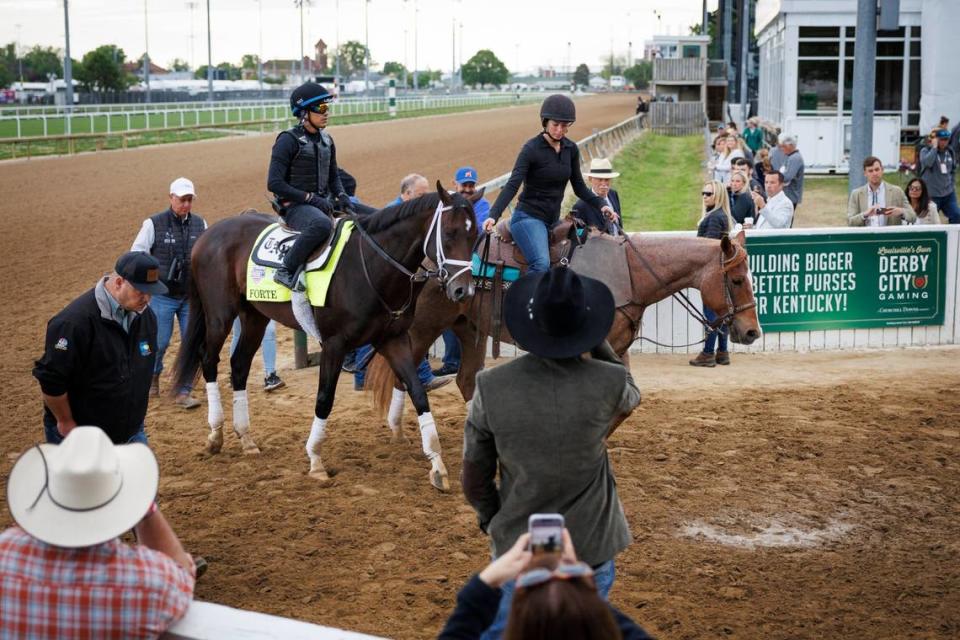 Kentucky Derby favorite Forte, with Hector Ramos-Cuti up, leaves the track after galloping Saturday morning. Pony Rider Mary Ellet, right, leads the colt off the track. Later in the morning Forte would be scratched after being examined by Kentucky Chief Veterinarian Nick Smith after a bruise on the colt’s right foot was discovered earlier in the week.