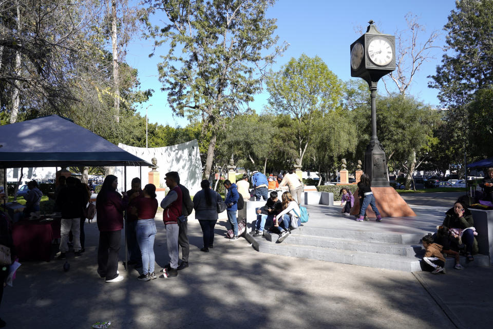 Migrants wait for help at a location set up by the city of Tijuana, Mexico to assist migrants with the CBPOne app Tuesday, Jan. 24, 2023, in Tijuana, Mexico. A mobile app for migrants to seek asylum in the United States has been oversaturated since it was introduced this month in one of several major changes to the government's response to unprecedented migration flows. Hoping to get lucky when a new appointments are made available daily, migrants are increasingly frustrated by a variety of error messages. (AP Photo/Gregory Bull)