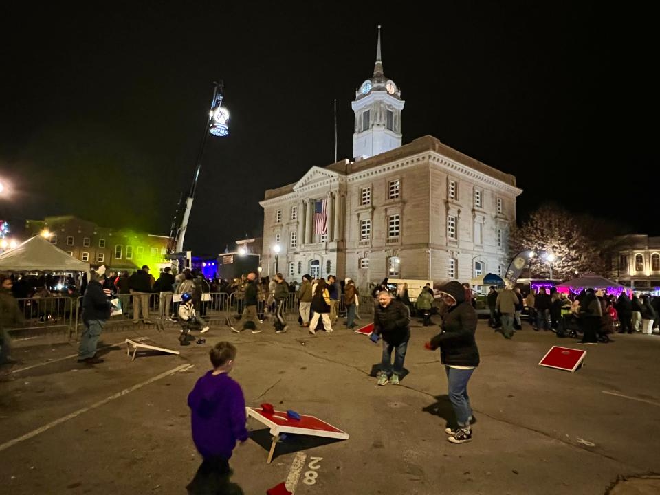 Downtown Columbia visitors take part in a game of cornhole during the fifth annual Mule Drop on Dec. 31, 2023.