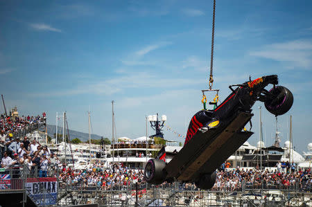 Formula One - Monaco Grand Prix - Monaco - 28/5/16. A crane lifts the car of Red Bull Racing's F1 driver Max Verstappen after his crash during the qualifying session. REUTERS/Andrej Isakovic/Pool