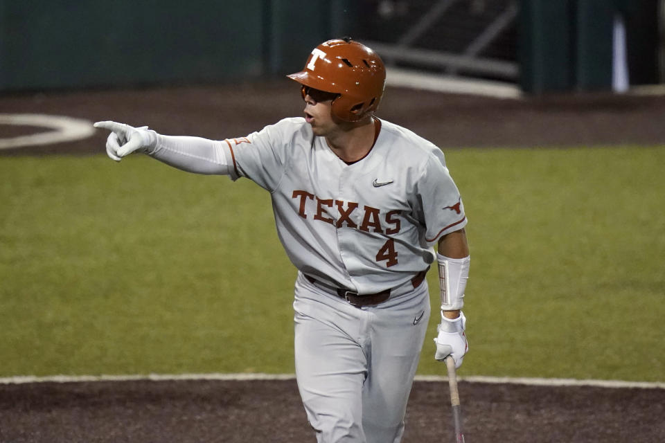 Texas' Silas Ardoin (4) reacts to his dugout after he was walked to load the bases during the fifth inning of an NCAA Super Regional college baseball game against South Florida, Sunday, June 13, 2021, in Austin, Texas. (AP Photo/Eric Gay)
