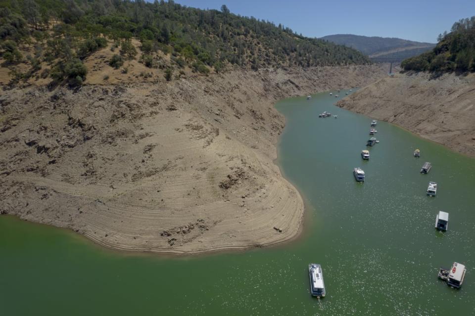 <div class="inline-image__caption"><p>Steep banks marked with previous water lines surround boats on Oroville Lake during low water levels in Oroville, California, U.S., on Tuesday, June 22, 2021. </p></div> <div class="inline-image__credit">Kyle Grillot/Bloomberg via Getty</div>