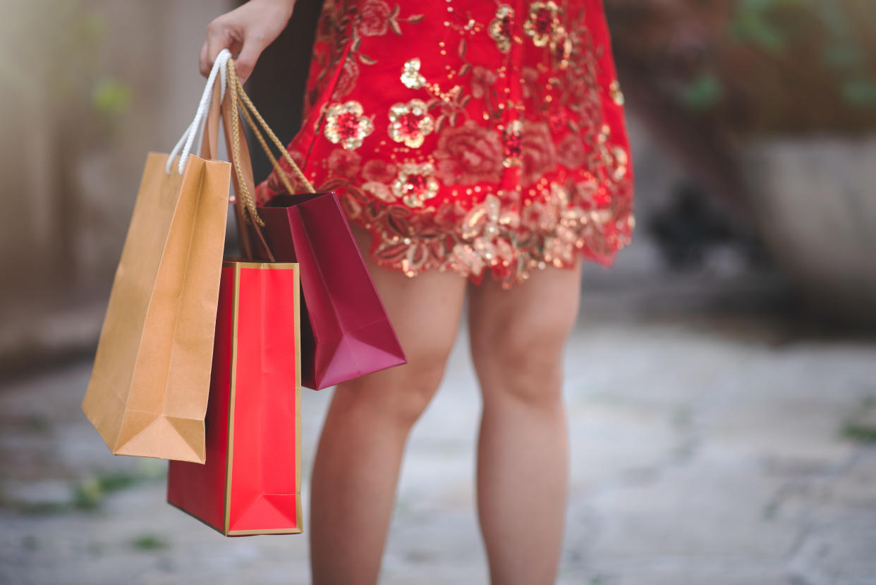 Close Up Asian Chinese Woman in Cheongsam Traditional Red Dress Holding Shopping Bag in Chinese New Year Festival