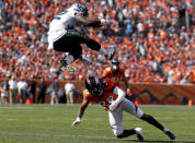 <p>Seattle Seahawks running back Chris Carson, above, gets over Denver Broncos defensive back Bradley Roby during the first half of an NFL football game Sunday, Sept. 9, 2018, in Denver. (AP Photo/David Zalubowski) </p>