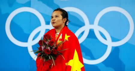 Chen Xiexia of China sings the national anthem after receiving her gold medal for the women's 48kg Group A weightlifting competition at the Beijing 2008 Olympic Games August 9, 2008. REUTERS/Oleg Popov (CHINA)