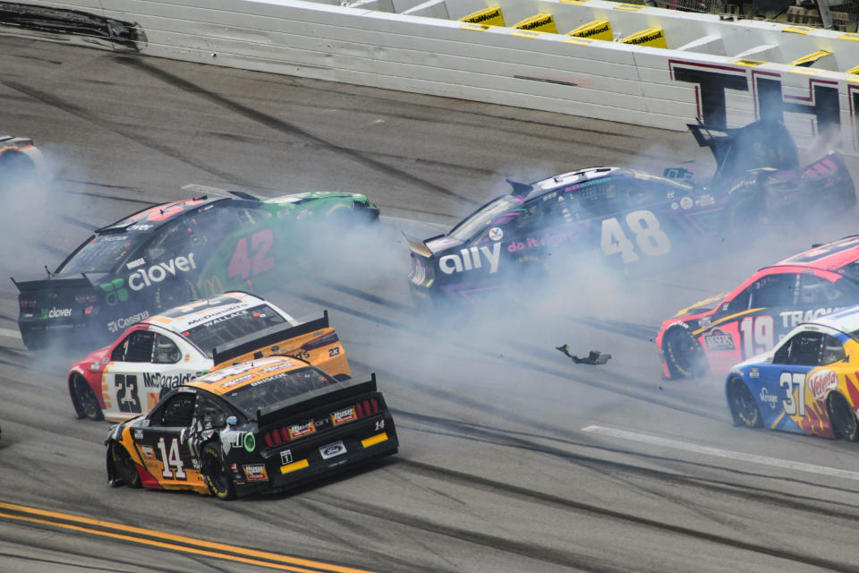 Ross Chastain (42) and Alex Bowman (48) get sideways during a NASCAR Cup series auto race Monday, Oct. 4, 2021, in Talladega, Ala. (AP Photo/Greg McWilliams)