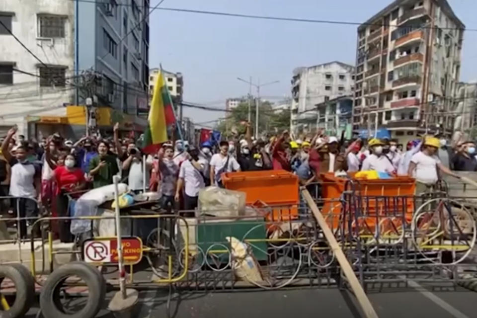 In this image made from video, anti-coup protesters shout at police in Yangon, Myanmar, Saturday, Feb. 27, 2021. Myanmar police on Saturday moved to clear anti-coup protesters from the streets of the country's biggest city Yangon. (AP Photo)