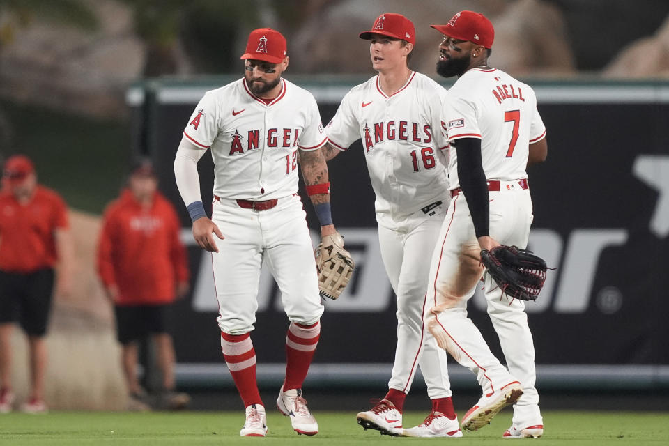 Los Angeles Angels left fielder Kevin Pillar, center fielder Mickey Moniak, and right fielder Jo Adell celebrate the team's win in a baseball game against the Detroit Tigers, Friday, June 28, 2024, in Anaheim, Calif. (AP Photo/Ryan Sun)