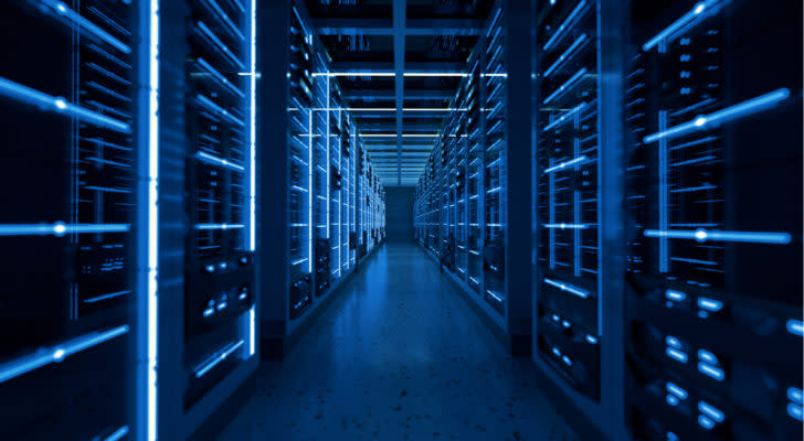 A hallway with server racks on either side in a data center