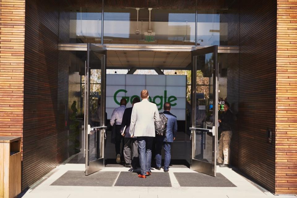 Executives walking into Google's headquarters entrance