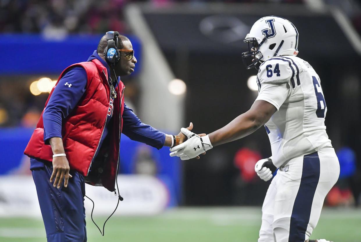 Jackson State Tigers coach Deion Sanders greets right tackle Deontae Graham during the Cricket Celebration Bowl on Dec. 17, 2022. <span> Austin McAfee/Icon Sportswire via Getty Images</span>