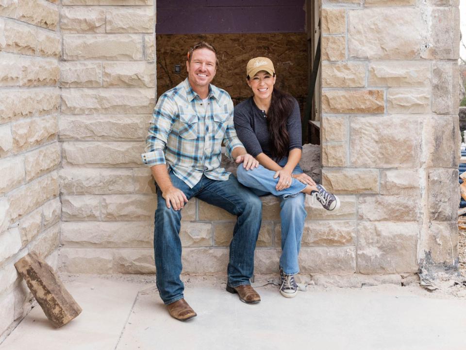 Chip and Joanna Gaines sit in the window of a castle.