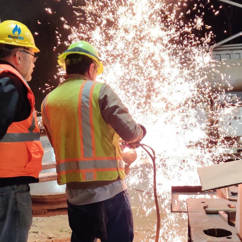 Workers demonstrate the use of MagneGas, a metal cutting fuel solution with superior flame temperature characteristics at a competitive price compared to acetylene, according to its manufacturer, Taronis Fuels Inc. The company plans to expand operations in Peoria.