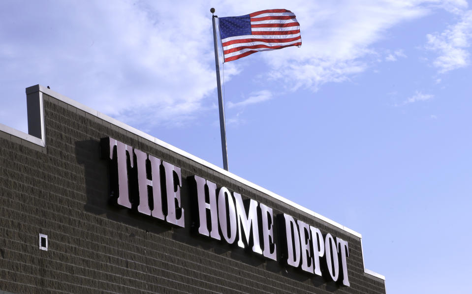 An American flag flies over a Home Depot store location, in Bellingham, Mass. (AP Photo/Steven Senne, File)