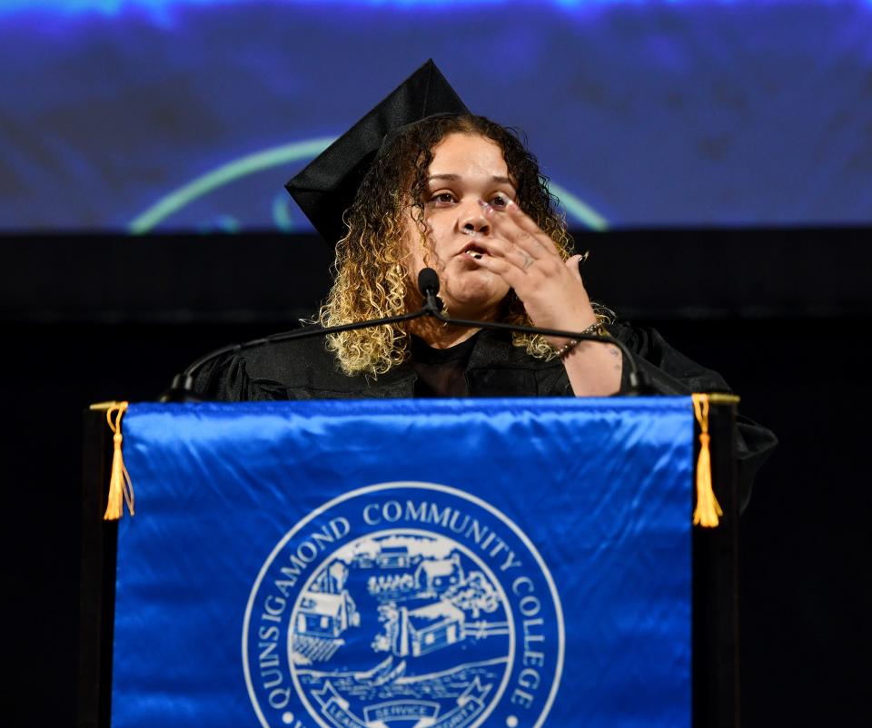 Dignamar Figueroa blows her two daughters a kiss as she provides student greetings during Quinsigamond Community College commencement exercises at the DCU Center on Friday.