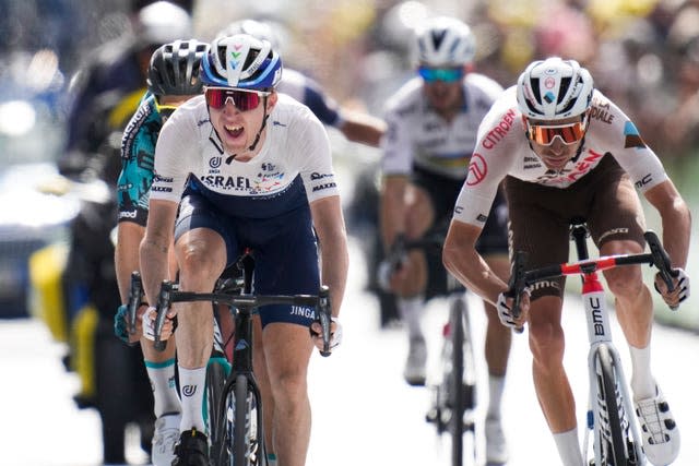 Daniel Martin, left, and France’s Aurelien Paret Peintre, right, cross the finish line on the 15th stage of the Tour de France