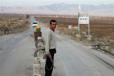 A Syrian Kurd Asaish stands at a security checkpoint at Derik in Al-Hasakah October 31, 2012. REUTERS/Thaier al-Sudani