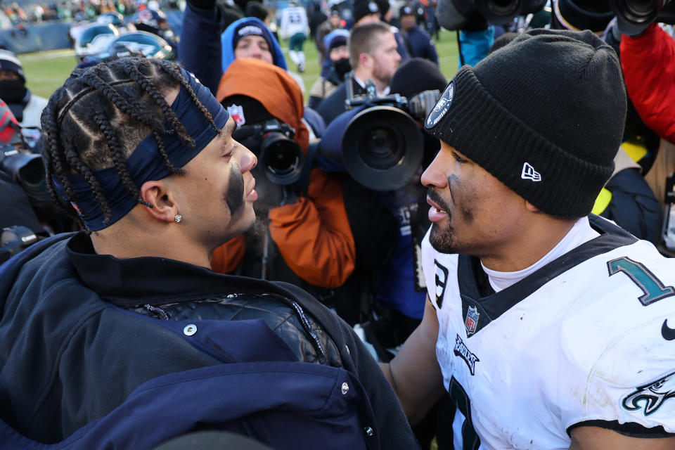CHICAGO, ILLINOIS - DECEMBER 18: Jalen Hurts #1 of the Philadelphia Eagles and Justin Fields #1 of the Chicago Bears embrace after the game at Soldier Field on December 18, 2022 in Chicago, Illinois. (Photo by Michael Reaves/Getty Images)