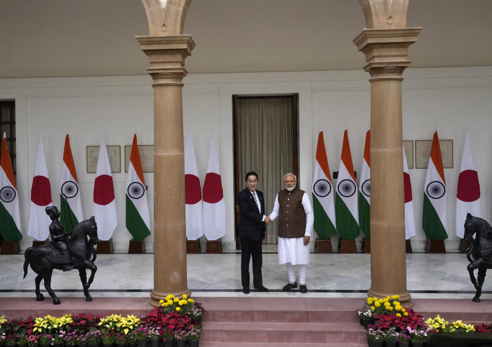 Japan’s Prime Minister Fumio Kishida, left and Indian Prime Minister Narendra Modi, pose for the media before their delegation level meeting in New Delhi, India, Monday, March 20, 2023. (AP Photo/Manish Swarup)