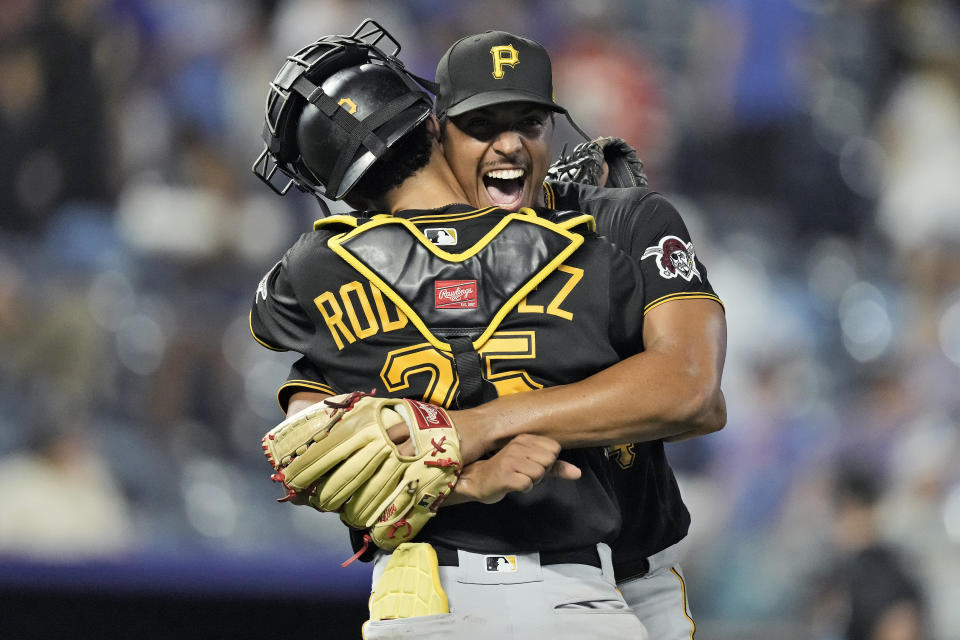 Pittsburgh Pirates starting pitcher Johan Oviedo, back, celebrates with catcher Endy Rodriguez after their baseball game against the Kansas City Royals Monday, Aug. 28, 2023, in Kansas City, Mo. Oviedo pitched a complete game leading the Pirates to a 5-0 win. (AP Photo/Charlie Riedel)