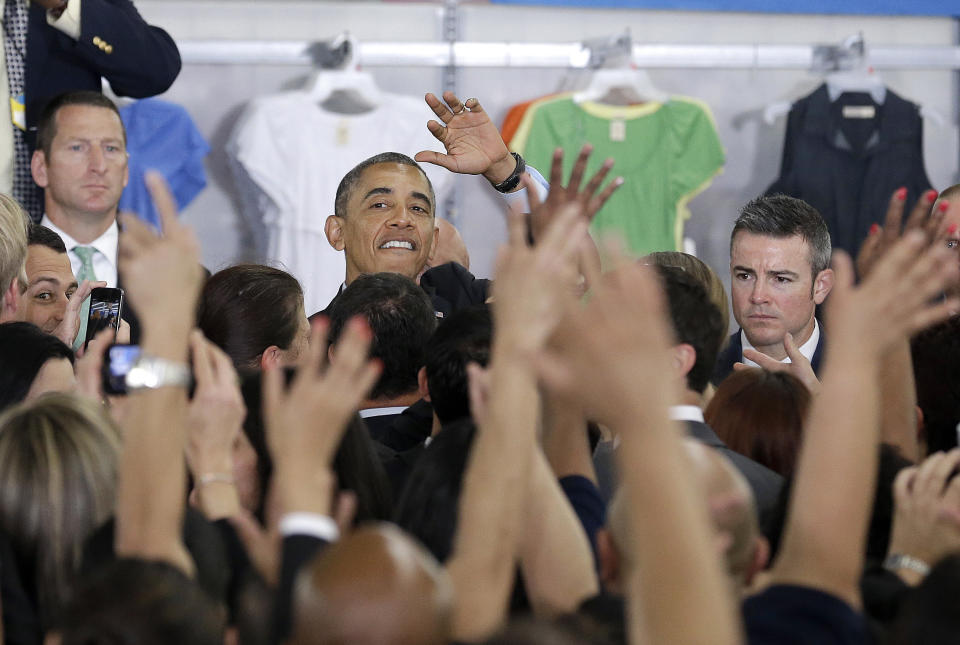 President Barack Obama waves after speaking at a Walmart store in Mountain View, Calif., Friday, May 9, 2014. Obama announced new steps by companies, local governments and his own administration to deploy solar technology, showcasing steps to combat climate change that don't require consent from a disinclined Congress. (AP Photo/Jeff Chiu)