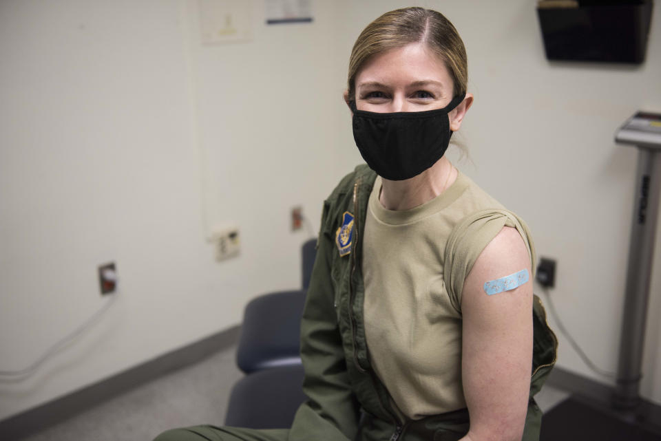KUNSAN, SOUTH KOREA - DECEMBER 29: (EDITORIAL USE ONLY) In this handout image provided by United States Forces Korea, U.S. Air Force Maj. Heather Foster poses for a photo after being the first recipient of the Moderna COVID-19 vaccine at Kunsan Air Base on December 29, 2020 in Kunsan, South Korea. United States Forces Korea (USFK) received the first shipment of Moderna's vaccine as Camp Humphreys was chosen by the U.S. government as one of four sites outside the continental U.S. that will receive the initial vaccination. (Photo by United States Forces Korea via Getty Images)