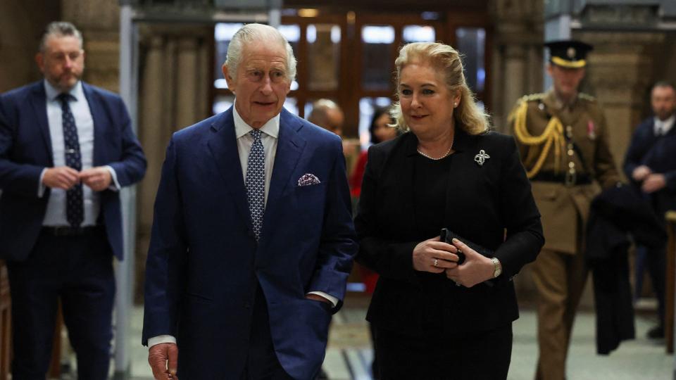 King Charles walking with Baroness Carr