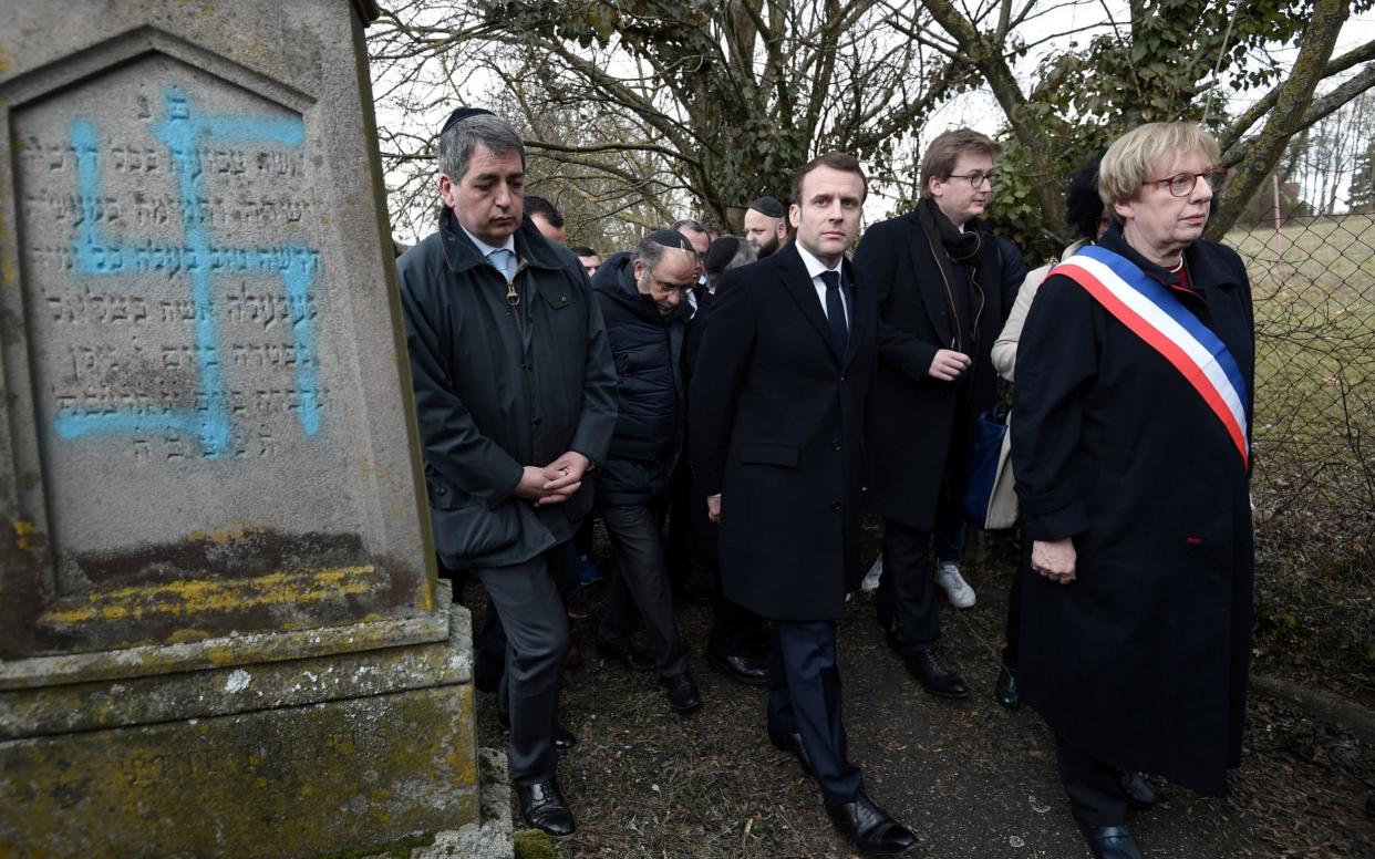 President Emmanuel Macron of France has promised to punish vandals who daubed dozens of graves with swastikas in a Jewish cemetery - REUTERS