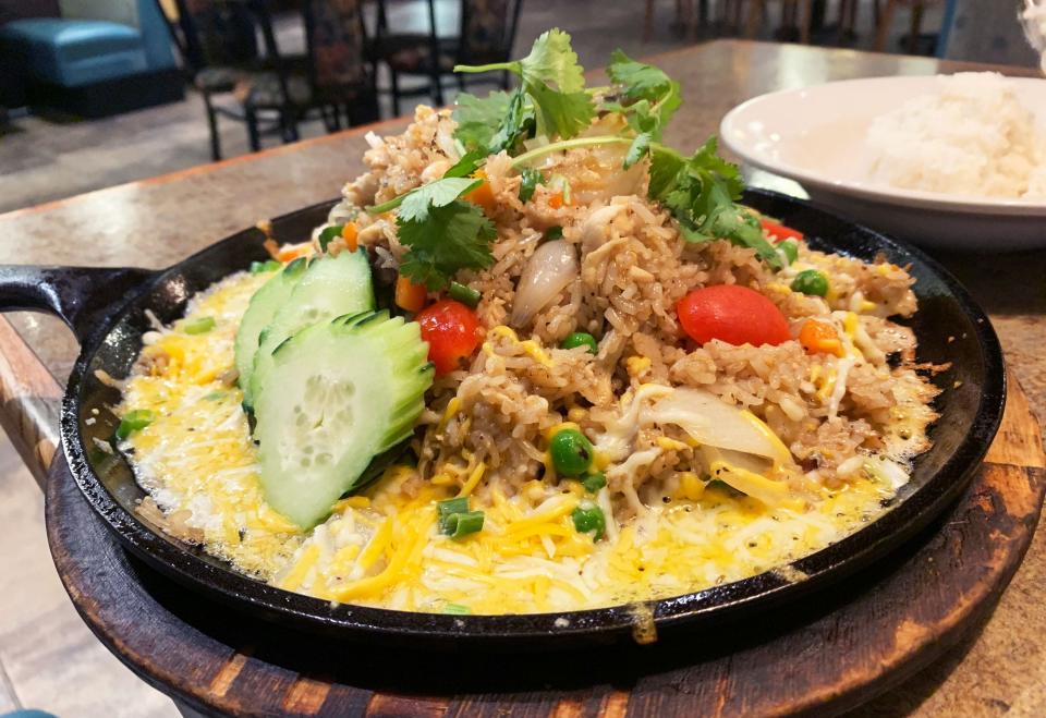 The fried rice at Café de Bangkok comes in a cast iron skillet with melted cheese.