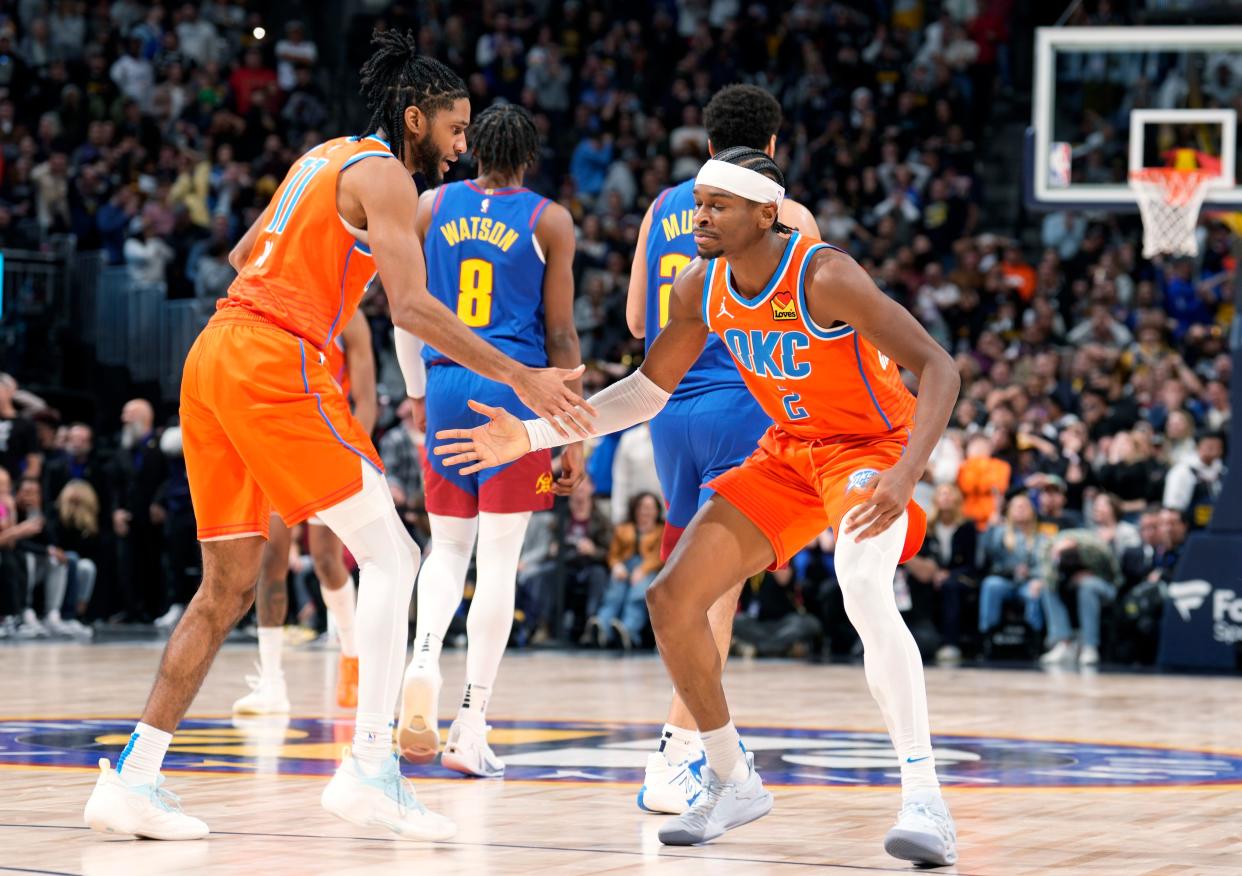 Oklahoma City Thunder guard Isaiah Joe, left, congratulates guard Shai Gilgeous-Alexander after Gilgeous-Alexander hit the winning basket with under a second remaining in the second half of an NBA basketball game against the Denver Nuggets, Saturday, Dec. 16, 2023, in Denver. (AP Photo/David Zalubowski)