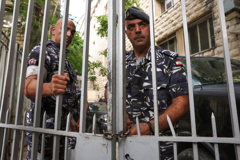 Lebanese police officers lock one of the doors of the Justice Palace in Beirut