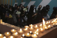 Protesters light candles at the site where student Chow Tsz-Lok fell during a recent protest in Hong Kong on Friday, Nov. 8, 2019. Chow, a Hong Kong university student who fell off a parking garage after police fired tear gas during clashes with anti-government protesters died Friday in a rare fatality after five months of unrest, fueling more outrage against authorities in the semi-autonomous Chinese territory. (AP Photo/Kin Cheung) ///