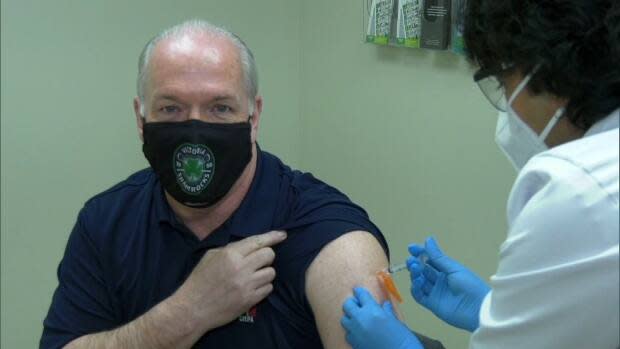 Premier John Horgan receiving his first dose of the AstraZeneca vaccine on Friday, April 16 in Victoria, B.C.