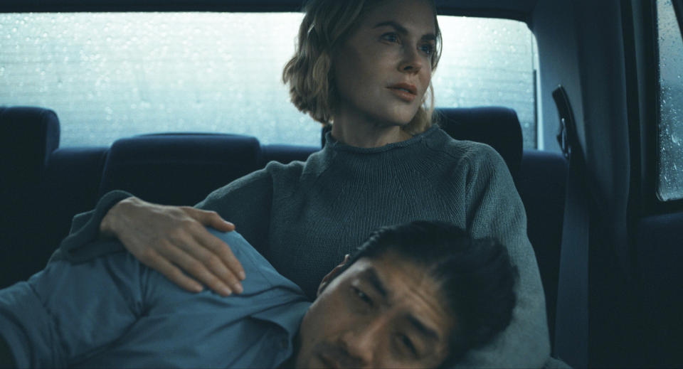 This image released by Prime Video shows Brian Tee, foreground, and Nicole Kidman in a scene from "The Expats." (Prime Video via AP)
