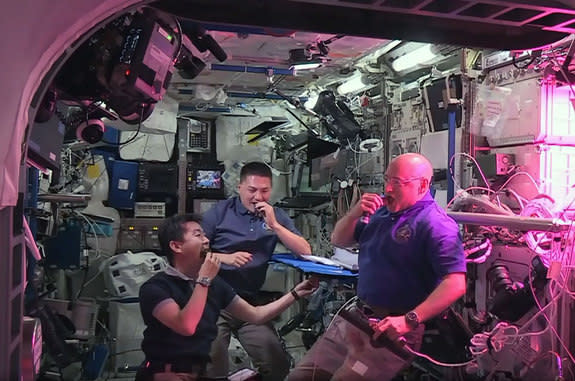 NASA astronauts Scott Kelly (right) and Kjell Lindgren (center) with Japanese astronaut Kimiya Yui snack on freshly harvested, space-grown red romaine lettuce as part of the Veggie experiment on the Internatio