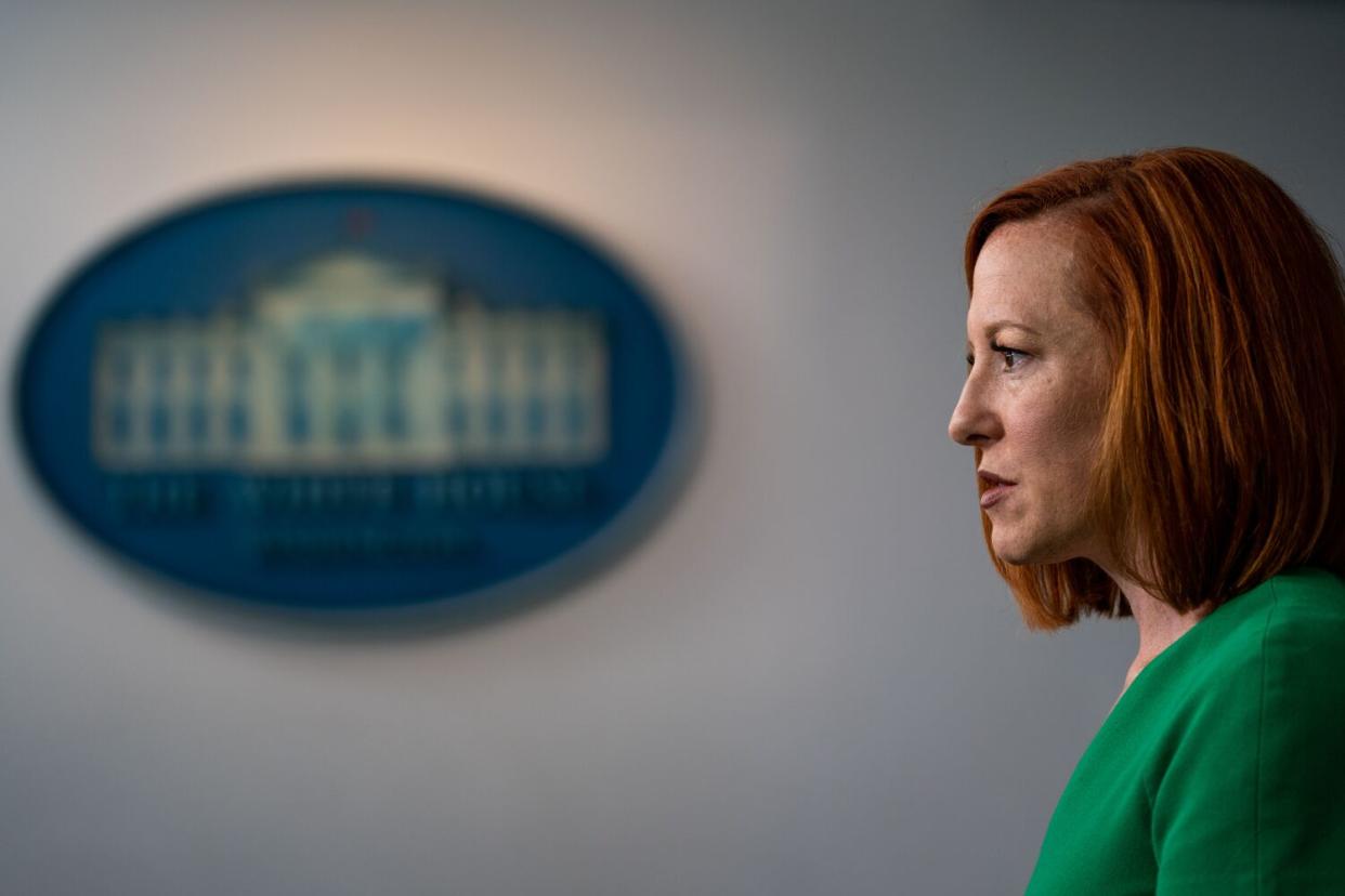 A red-haired woman in a green top speaks during a press briefing at the White House in 2021.