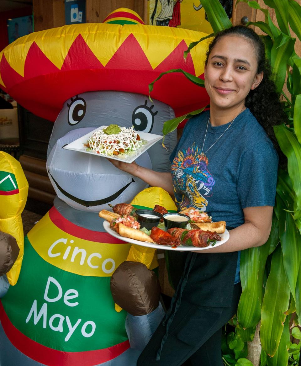 At Sol de Mexico Cafe and Grill in Natick,  Adalysa Niyanilet serves up an appetizer sampler and avocado mango salad, May 3, 2023. Friday is Cinco de Mayo. 