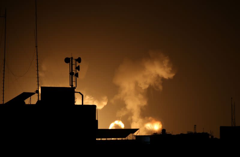 Flame and smoke are seen during Israeli air strikes in the southern Gaza Strip