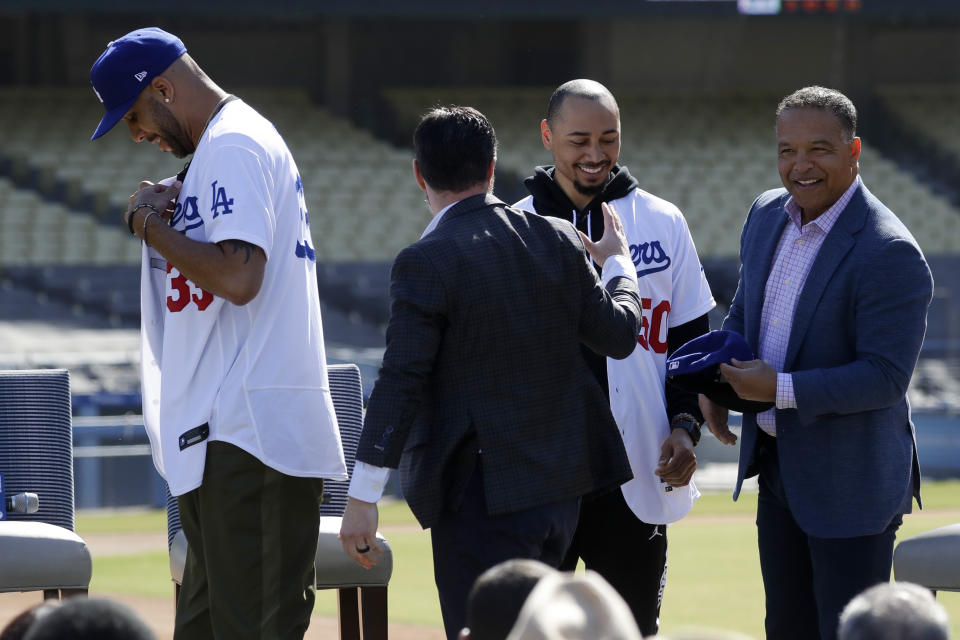 New Los Angeles Dodgers players David Price and Mookie Betts are greeted by Dodger President, Baseball Operations, Andrew Friedman and manager Dave Roberts during a news conference to announce their acquisition at the Dodger Stadium in Los Angeles, Wednesday, Feb. 12, 2020. (AP Photo/Chris Carlson)