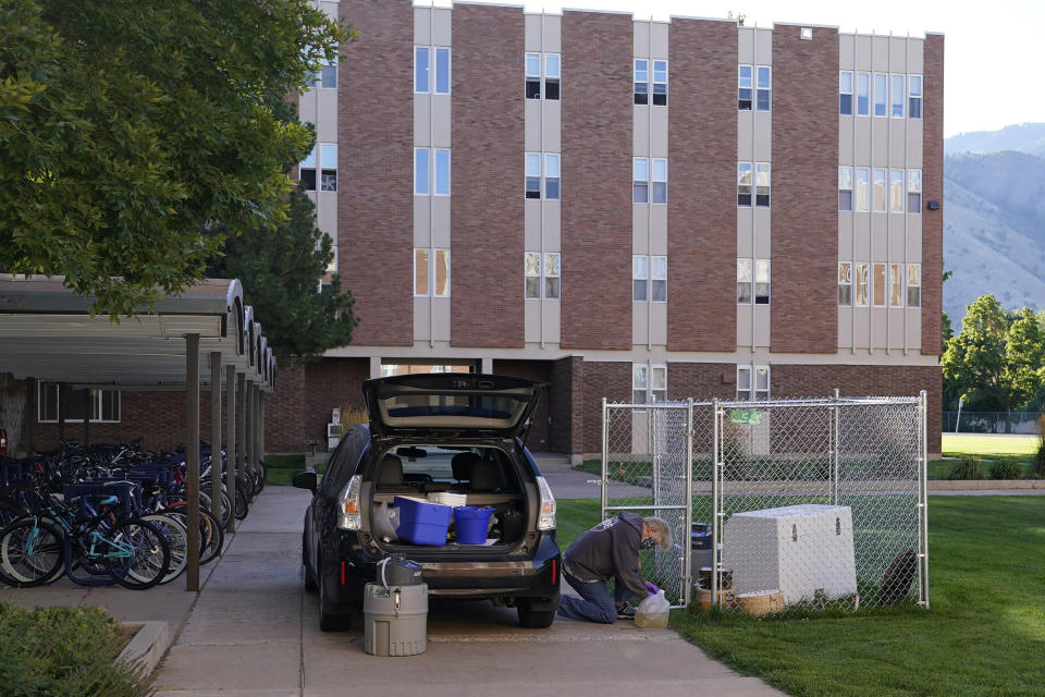 Ryan Dupont, Utah State University Professor of Civil & Environmental Engineering, collects sewage samples from the dorms at Utah State University Wednesday, Sept. 2, 2020, in Logan, Utah. About 300 students are quarantined to their rooms this week, but not because anyone got sick or tested positive. Instead, the warning bells came from the sewage. Colleges around the country are monitoring wastewater in hopes of stopping coronavirus outbreaks before they get out of hand. Utah State became at least the second school to quarantine hundreds of students after sewage tests detected the virus. (AP Photo/Rick Bowmer)