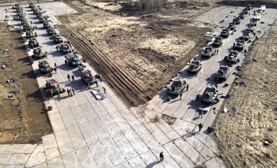 FILE - This photo taken from video distributed by Russian Defense Ministry Press Service shows Russian military vehicles move during drills in Crimea on April 22, 2021. Russia's present demands are based on Putin's purported long sense of grievance and his rejection of Ukraine and Belarus as truly separate, sovereign countries but rather as part of a Russian linguistic and Orthodox motherland. (Russian Defense Ministry Press Service via AP, File)