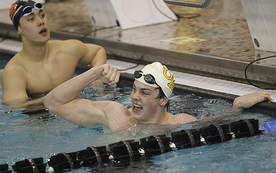 Upper Arlington's Grant Gooding celebrates after winning the Division I state title in the 100-yard breaststroke Feb. 26 at Branin Natatorium in Canton.