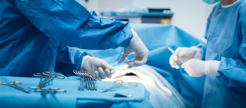 Doctor and nurse in the surgery room with a patient