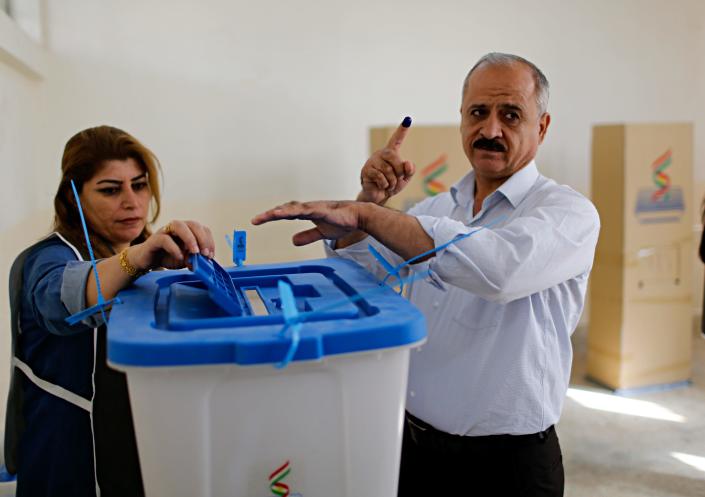An Iraqi Kurdish man holds up his finger marked with ink as he casts his ballot during parliamentary elections in Irbil, Iraq, Sunday, Sept. 30, 2018. Iraq's self-ruled Kurdish region was holding long-delayed parliamentary elections on Sunday, a year after a vote for independence sparked a punishing backlash from Baghdad, leaving Kurdish leaders deeply divided. (AP Photo)