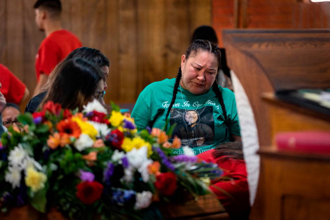 Erica Trevino stands beside her son’s casket during his funeral in Waurika, Oklahoma, on Saturday, Jan. 28, 2023. Zechariah Trevino, killed by gun violence on Jan. 20, was remembered as a loving, funny person throughout the service.