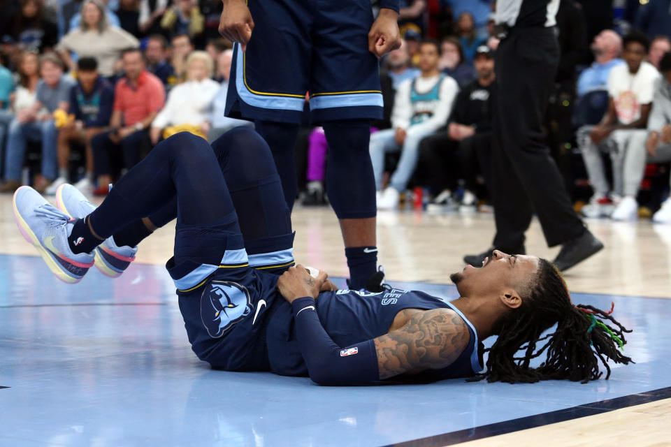 Apr 16, 2023; Memphis, Tennessee, USA; Memphis Grizzlies guard Ja Morant (12)reacts after falling to the ground during the second half during game one of the 2023 NBA playoffs against the Los Angeles Lakers at FedExForum. Mandatory Credit: Petre Thomas-USA TODAY Sports