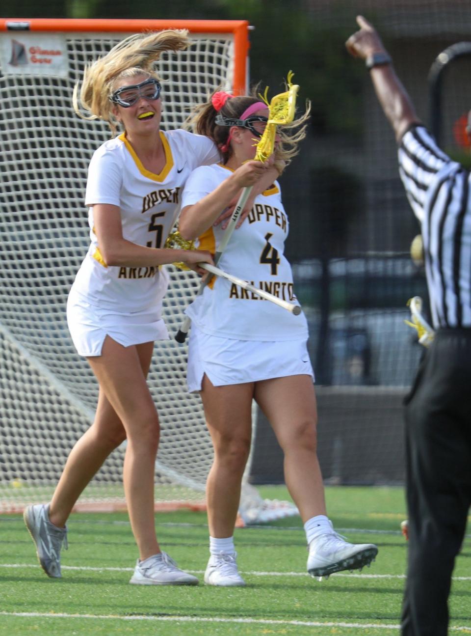 Upper Arlington's Rian Adkins (50) congratulates Camryn Callaghan (4) after a goal against Dublin Coffman during the Division I, Region 1 final May 25. The Golden Bears beat the visiting Shamrocks 17-7.
